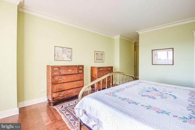 bedroom featuring ornamental molding and wood-type flooring