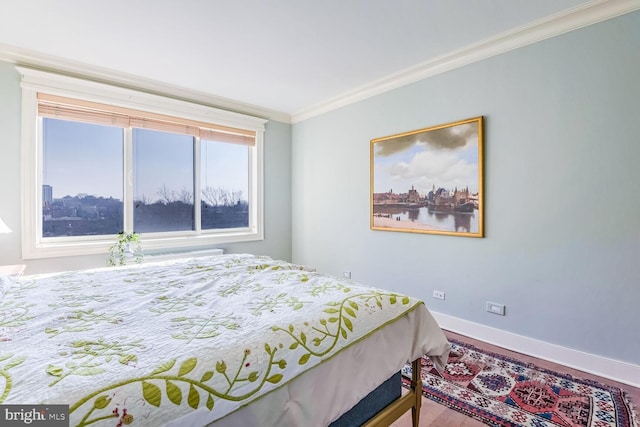 bedroom with crown molding and hardwood / wood-style floors