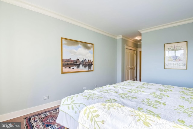 bedroom with crown molding and hardwood / wood-style flooring