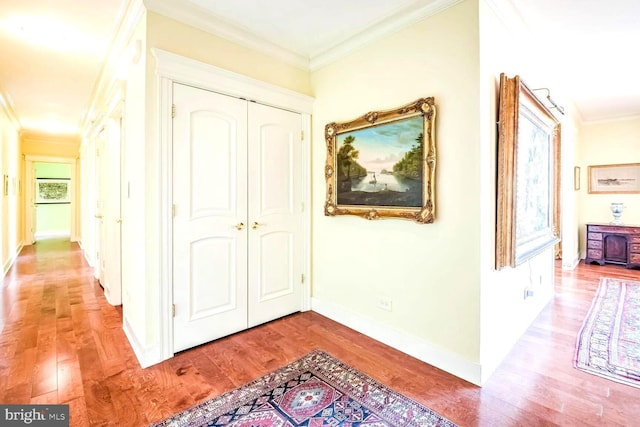 corridor featuring ornamental molding and light hardwood / wood-style floors