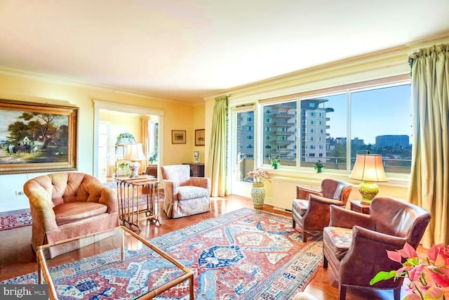 living area featuring crown molding and hardwood / wood-style floors