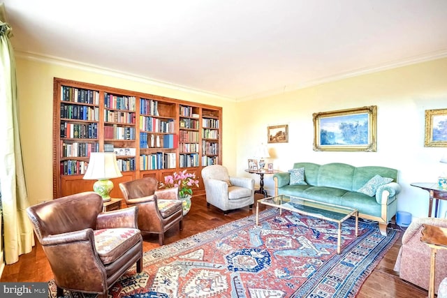 sitting room with dark hardwood / wood-style flooring and ornamental molding