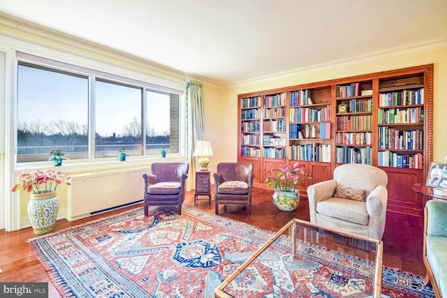 living area featuring crown molding and hardwood / wood-style floors