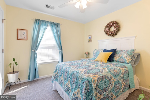 bedroom with ceiling fan, carpet floors, and multiple windows