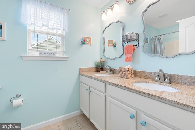 bathroom with tile patterned floors, curtained shower, and vanity