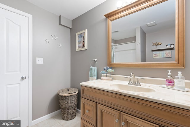 bathroom featuring vanity, a shower, and tile patterned floors