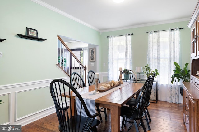 dining area featuring ornamental molding and dark hardwood / wood-style flooring