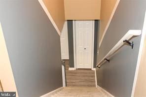 stairway featuring hardwood / wood-style flooring