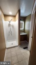 bathroom with vanity and a shower