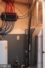 utility room featuring water heater