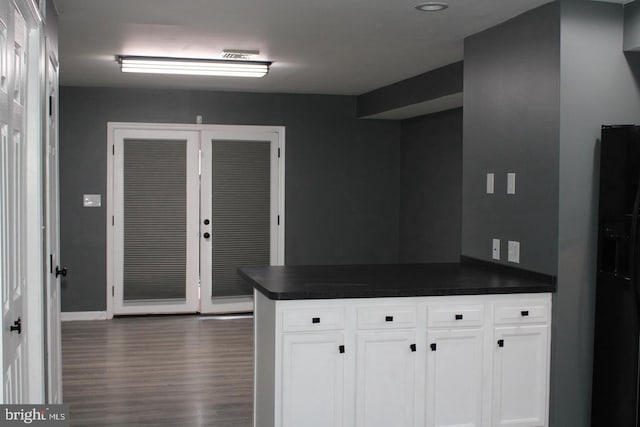 kitchen with white cabinets and dark hardwood / wood-style flooring