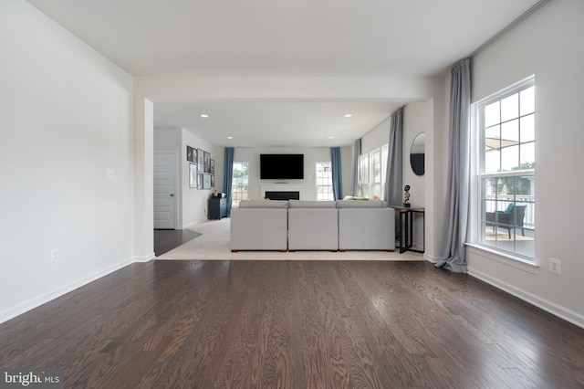 unfurnished living room with hardwood / wood-style flooring and a wealth of natural light