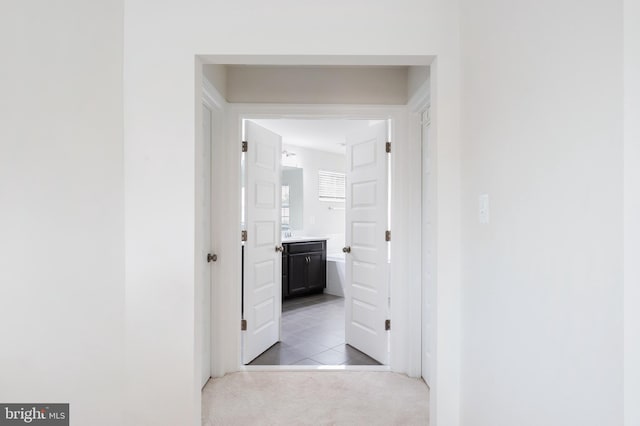 corridor with light colored carpet