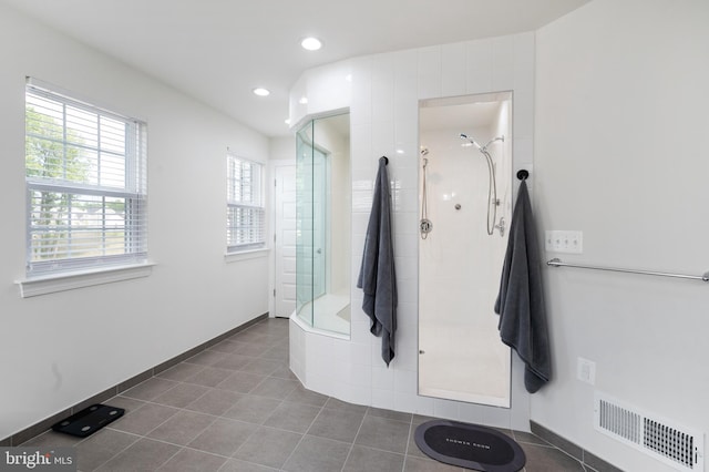 bathroom with tile patterned flooring and tiled shower