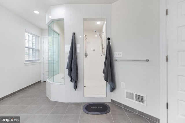 bathroom with tile patterned flooring and an enclosed shower