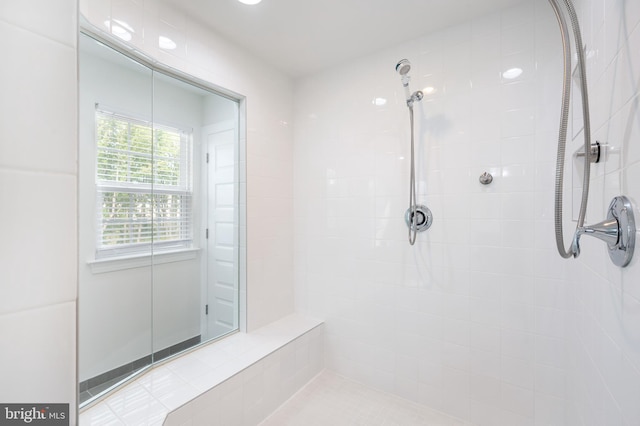 bathroom with a tile shower