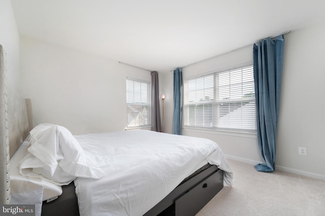 bedroom featuring light carpet