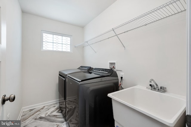 laundry area featuring sink, separate washer and dryer, and light parquet floors