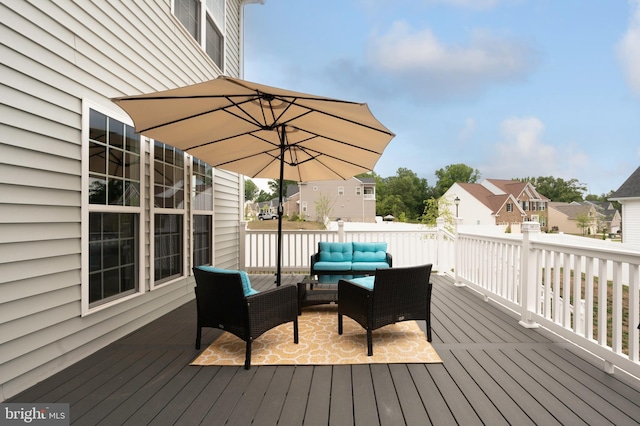 wooden terrace with an outdoor living space