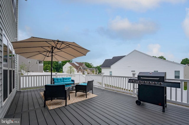 wooden deck featuring an outdoor living space and area for grilling