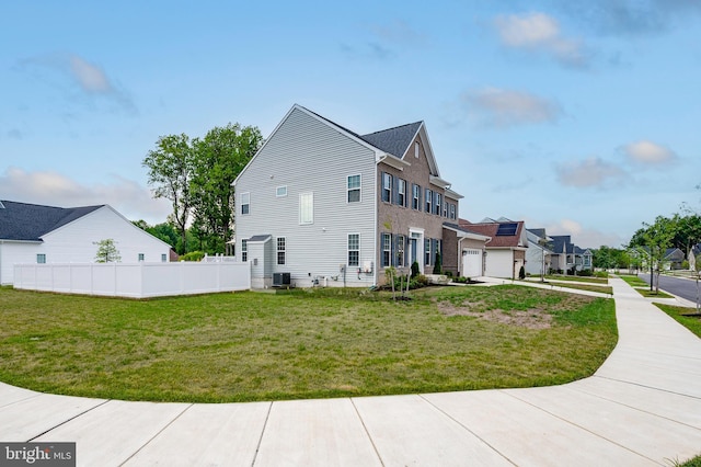 view of property exterior with a garage, a lawn, and central air condition unit