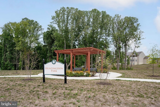 view of home's community with a pergola and a lawn