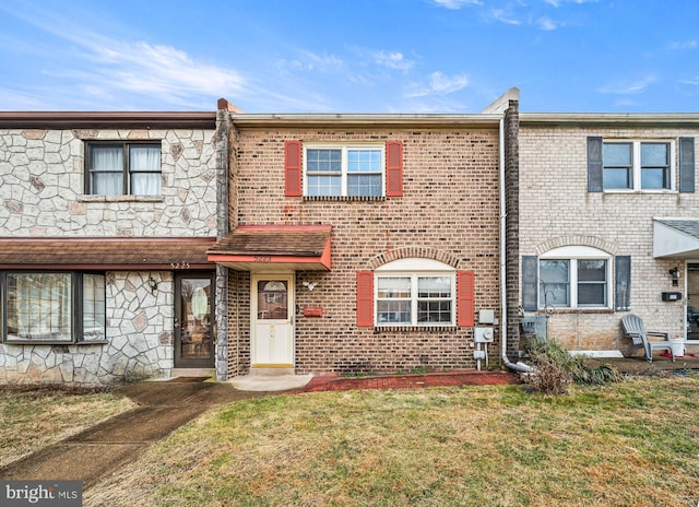 townhome / multi-family property featuring a front yard