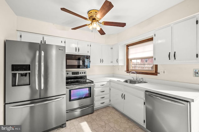 kitchen with white cabinetry, sink, stainless steel appliances, and ceiling fan