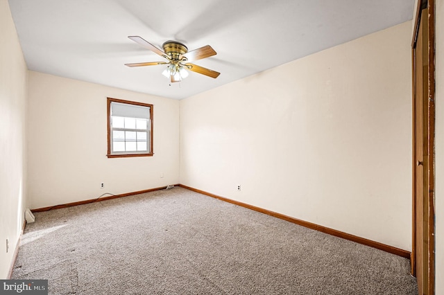 carpeted empty room featuring ceiling fan