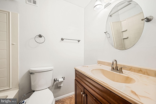 bathroom featuring vanity, toilet, and a shower