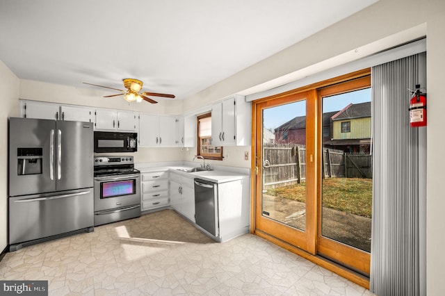 kitchen with ceiling fan, stainless steel appliances, sink, and white cabinets