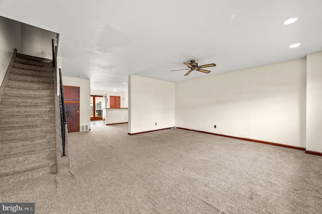 unfurnished living room featuring ceiling fan and carpet