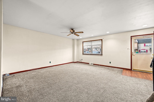 unfurnished room with carpet floors, a wealth of natural light, and ceiling fan