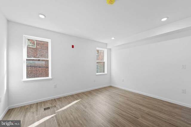 unfurnished room with light wood-type flooring