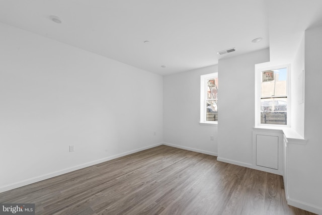 empty room with hardwood / wood-style flooring