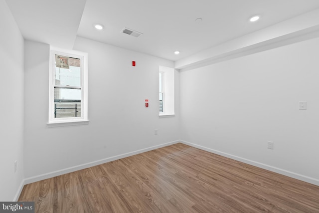 spare room featuring wood-type flooring