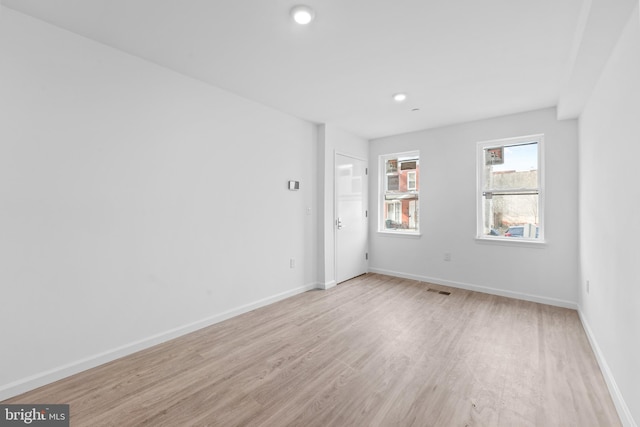 unfurnished room with light wood-type flooring