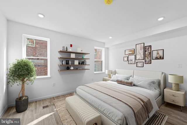 bedroom with hardwood / wood-style flooring