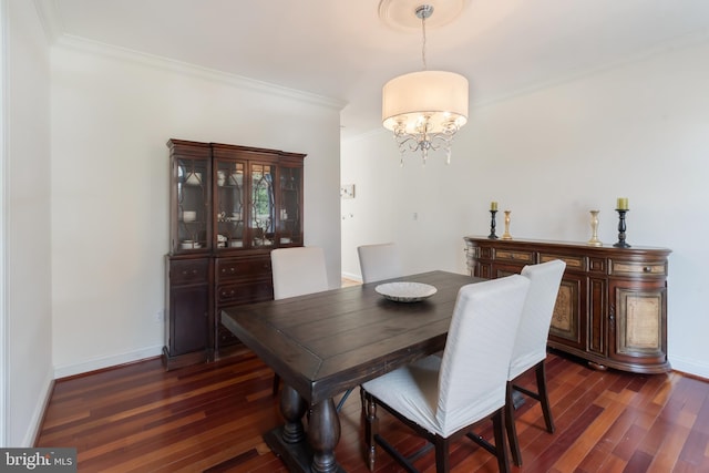 dining area featuring baseboards, a notable chandelier, dark wood-style floors, and crown molding