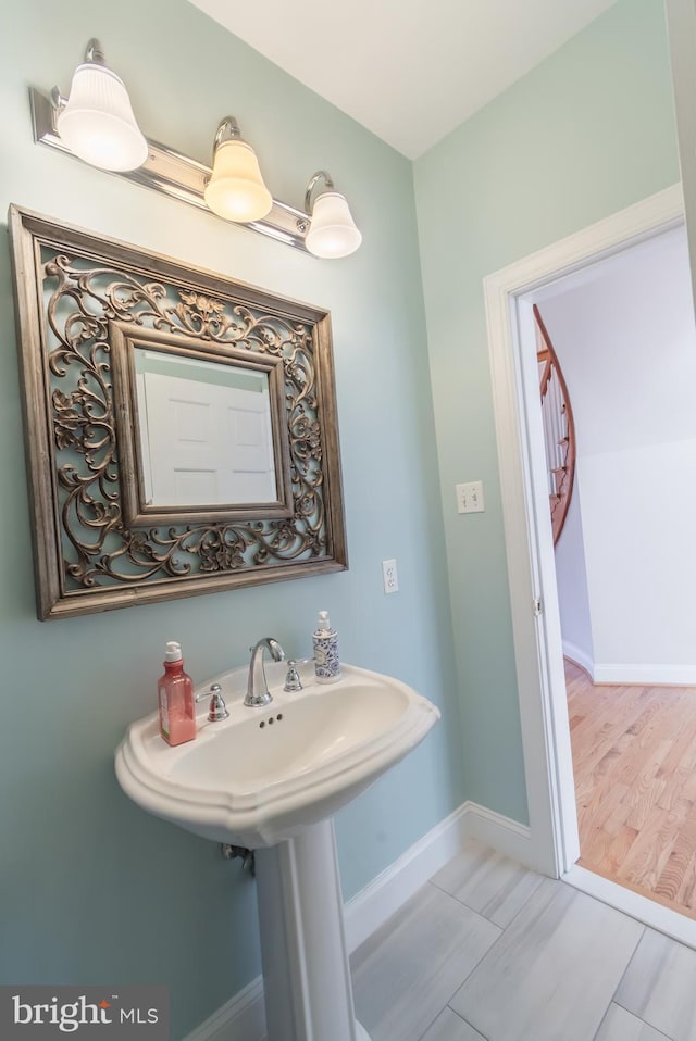 bathroom featuring wood finished floors and baseboards