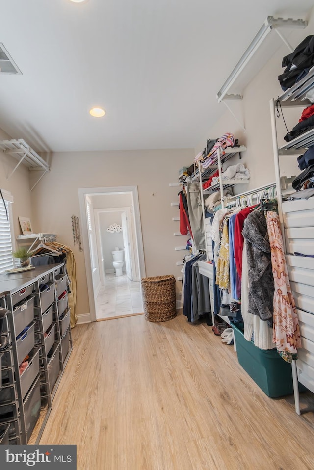 walk in closet with visible vents and wood finished floors