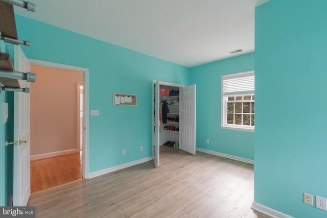 unfurnished bedroom with visible vents, baseboards, and light wood finished floors