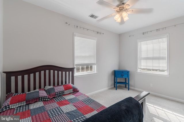 bedroom with visible vents, baseboards, carpet floors, and ceiling fan