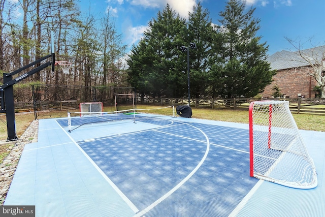 view of basketball court with community basketball court and fence