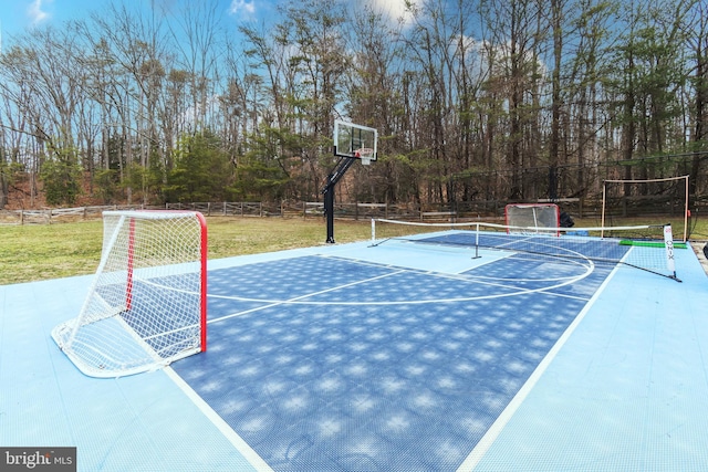 view of basketball court with community basketball court and fence