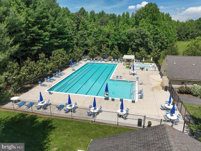 community pool featuring a patio area and fence