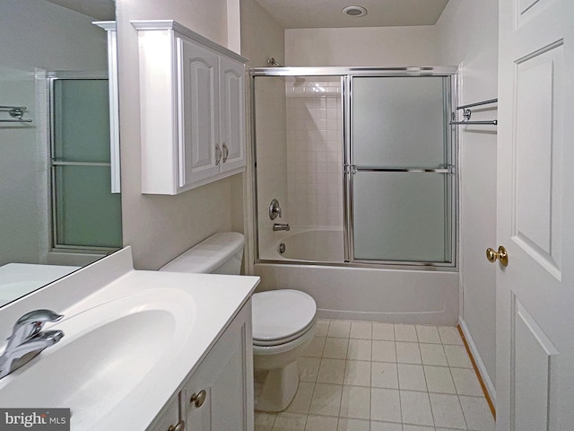 full bathroom featuring enclosed tub / shower combo, vanity, toilet, and tile patterned floors