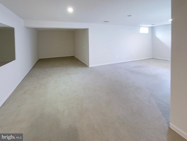 basement featuring light carpet