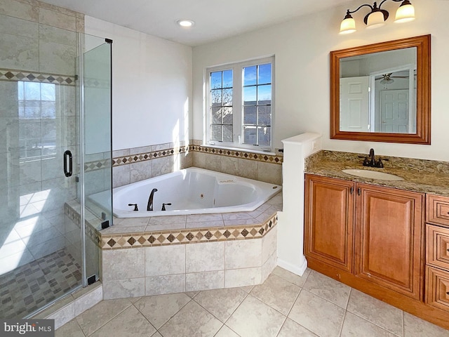 bathroom with shower with separate bathtub, vanity, and tile patterned floors