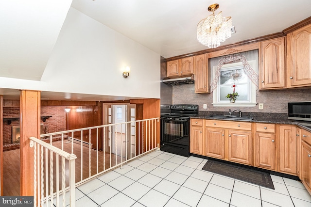 kitchen featuring sink, backsplash, dark stone counters, light tile patterned floors, and black range with electric stovetop